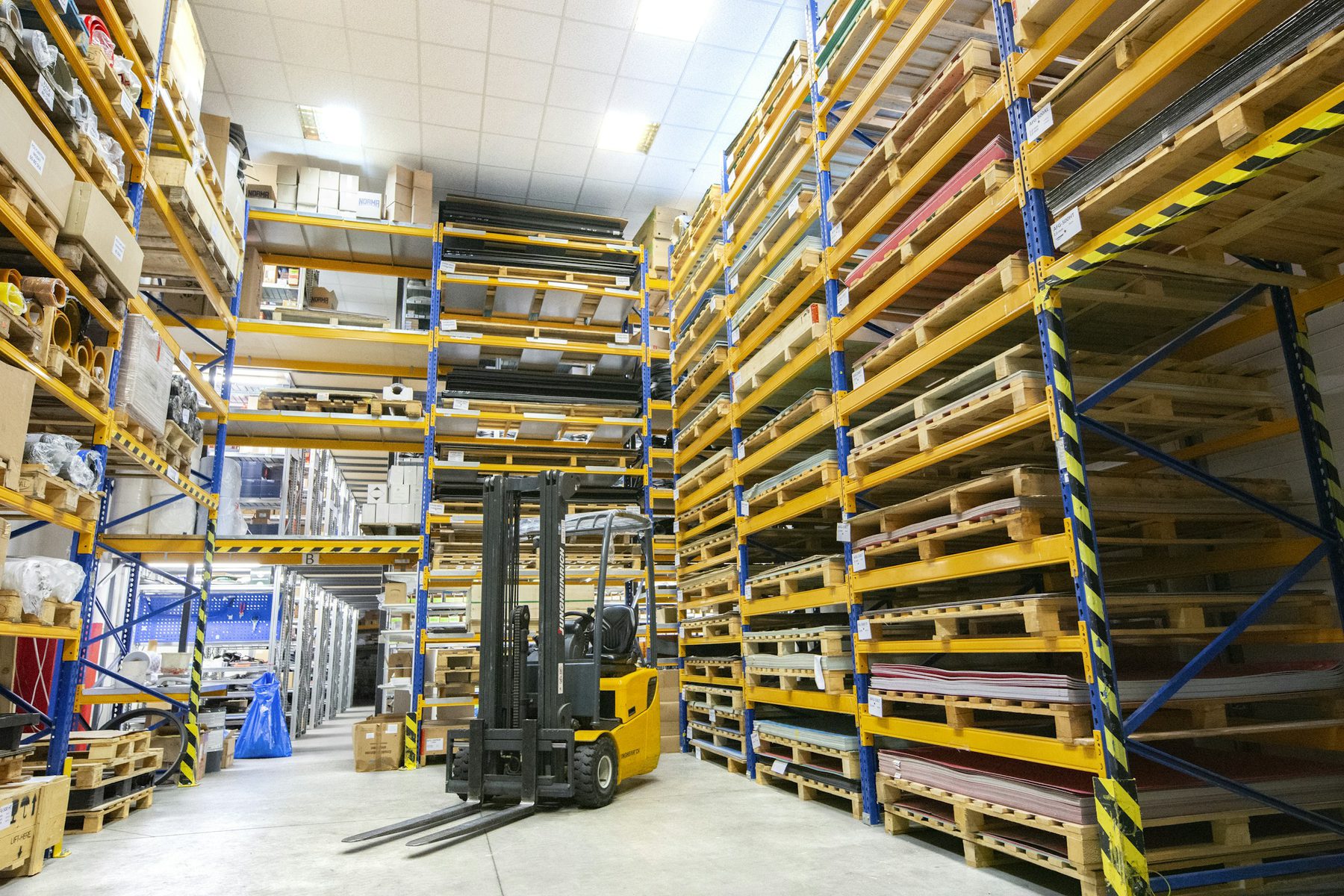 Warehouse racking stacked with pallets of finished stock held as safety inventory